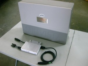 A Micro-inverter (210 Watt Enphase M210) sits in front of a Central "String" Inverter (3500 Watt SunVista by Sharp Electronics)