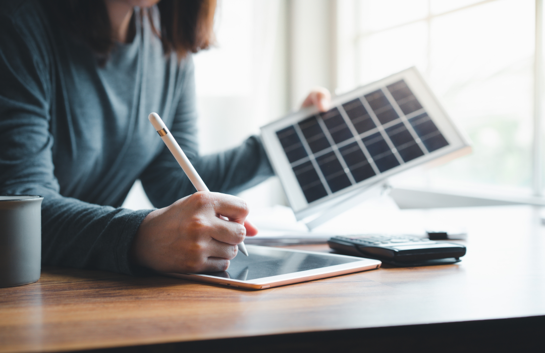 woman holding a small solar panel
