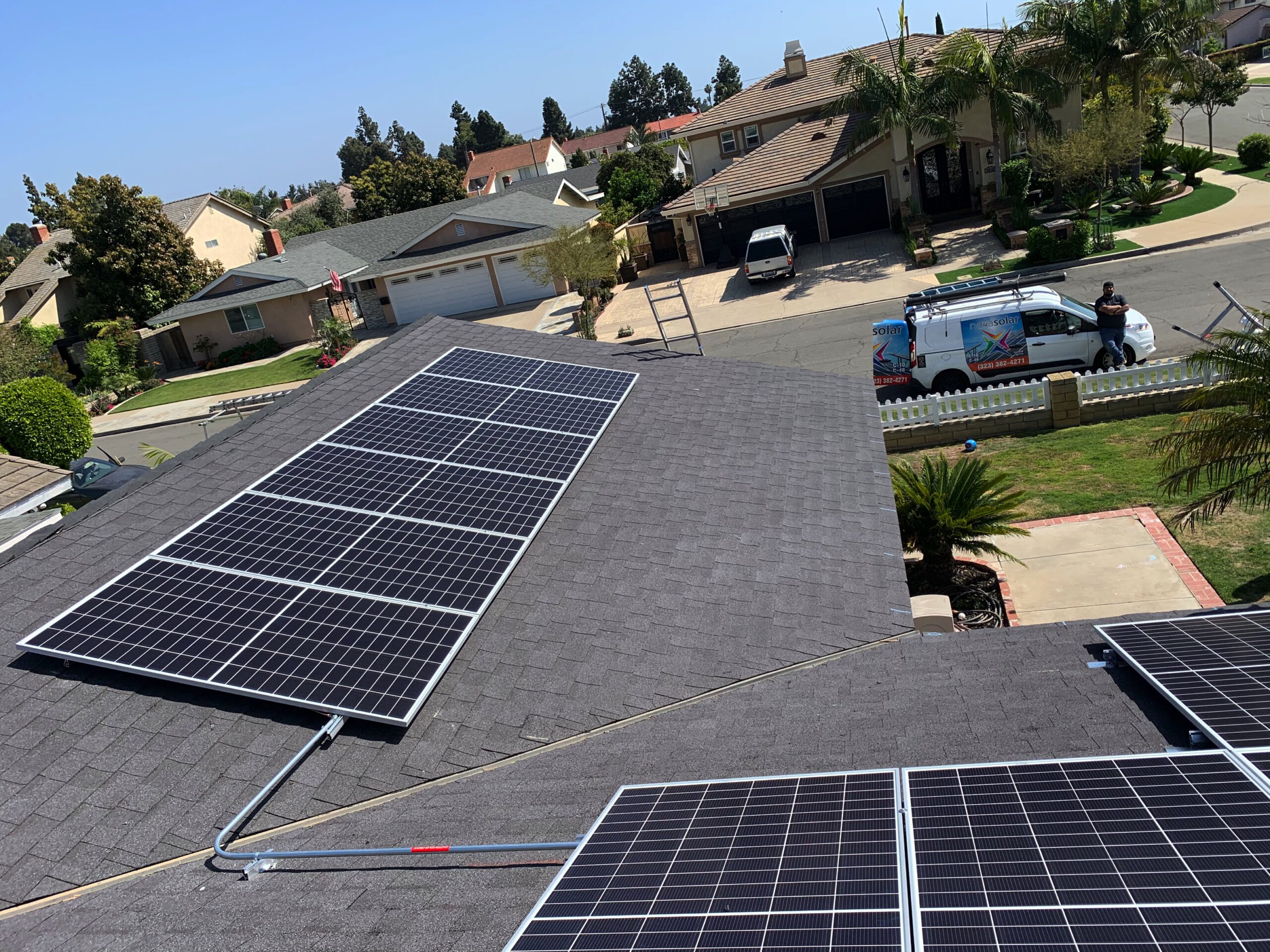 Rooftop solar panel installation on a Fountain Valley home by AMECO Solar & Roofing with a company v…